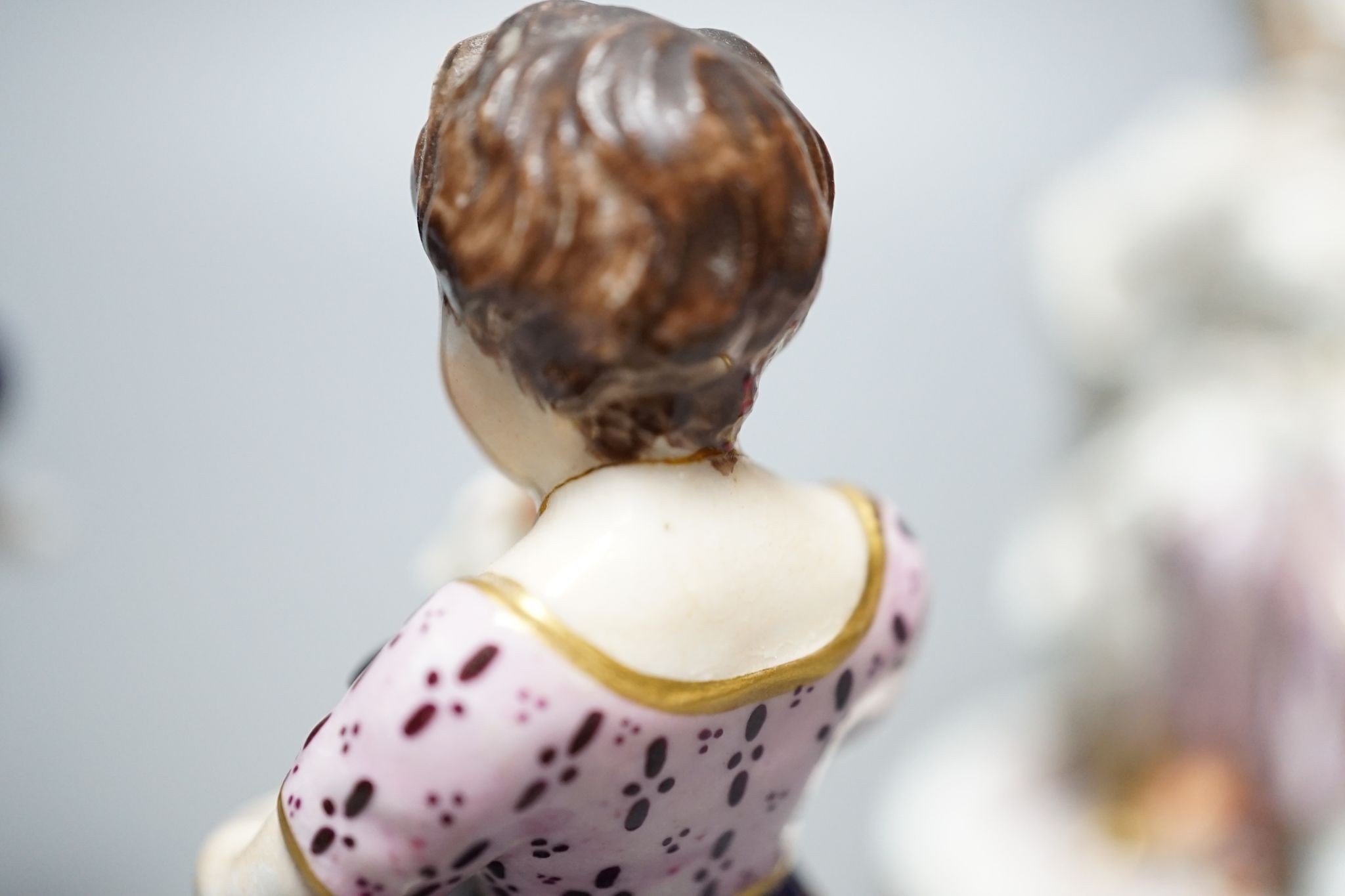 A Minton porcelain figure of a lady seated with a dog c.1830, a pair of Derby figures of a girl and a boy with a dog and a sheep, and a Bloor Derby vase